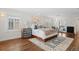 Spacious bedroom with hardwood floors, ensuite access, and bright light from multiple windows at 815 Gaylord St, Denver, CO 80206