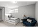 Charming bedroom with a twin bed, a blue accent chair, and a neutral color scheme for a relaxing retreat at 815 Gaylord St, Denver, CO 80206