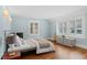 Sun-filled bedroom with hardwood floors, a comfortable bed, and built-in window seating at 815 Gaylord St, Denver, CO 80206