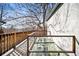 A spacious deck with transparent floor and wood railing is situated next to a house at 815 Gaylord St, Denver, CO 80206