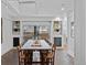 Bright dining room with skylight, large wooden table, and built-in shelving at 815 Gaylord St, Denver, CO 80206