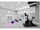 Bright exercise room with a stationary bike, yoga mats, and built-in storage cabinets, ideal for fitness at 815 Gaylord St, Denver, CO 80206