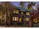 Dusk view of brick home highlighting the architectural details and warm interior lighting at 815 Gaylord St, Denver, CO 80206