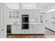 Modern kitchen with white cabinets, a double oven, and a wine cooler at 815 Gaylord St, Denver, CO 80206