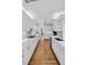 Bright, spacious kitchen featuring white cabinetry, hardwood floors, and modern fixtures at 815 Gaylord St, Denver, CO 80206