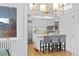 Open kitchen featuring a center island with barstool seating, stainless steel appliances, and a modern chandelier at 815 Gaylord St, Denver, CO 80206