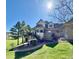 This backyard features a large deck and beautifully landscaped greenery at 5 Catamount Ln, Littleton, CO 80127