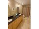 Bathroom with double sinks, granite countertop and tile floor at 5 Catamount Ln, Littleton, CO 80127