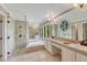 Spacious bathroom boasts dual sinks, tiled shower, and a soaking tub with many windows at 5 Catamount Ln, Littleton, CO 80127
