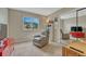 Relaxing bedroom featuring plush carpet, chair, and natural light at 5 Catamount Ln, Littleton, CO 80127