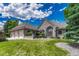 Charming single Gathering home with brick exterior, manicured lawn, and three-car garage at 5 Catamount Ln, Littleton, CO 80127