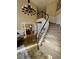 Bright foyer with staircase, chandelier, and wood-trimmed walls at 5 Catamount Ln, Littleton, CO 80127