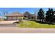 Charming brick home boasts a three-car garage and a well-manicured lawn at 5 Catamount Ln, Littleton, CO 80127