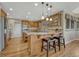Spacious eat-in kitchen featuring wooden floors, stone countertops, and stainless appliances at 5 Catamount Ln, Littleton, CO 80127