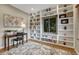 Home office with built-in bookshelves, a desk, and a window at 5 Catamount Ln, Littleton, CO 80127