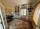 Bright home office with custom built-in shelving, hardwood floors and natural light at 5 Catamount Ln, Littleton, CO 80127
