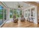 Bright sun room with ceiling fan, hardwood floors, and large windows at 5 Catamount Ln, Littleton, CO 80127