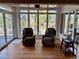 Cozy sun room with hardwood floors, comfortable seating and large windows at 5 Catamount Ln, Littleton, CO 80127