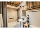 Stylish bathroom featuring modern fixtures, a bathtub, and a unique wood-paneled ceiling at 1941 Boreas Pass Rd # 1C, Breckenridge, CO 80424