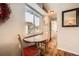 Charming dining area with a round table, two chairs, and a window offering lovely views at 1941 Boreas Pass Rd # 1C, Breckenridge, CO 80424