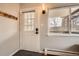 Bright entryway featuring a window, coat rack, and stylish front door with mountain views at 1941 Boreas Pass Rd # 1C, Breckenridge, CO 80424