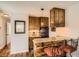 Compact kitchen bar featuring wood cabinetry, granite countertops, and modern fixtures at 1941 Boreas Pass Rd # 1C, Breckenridge, CO 80424