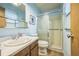 Well-lit bathroom with a shower and sliding glass door, complemented by a clean sink and toilet at 490 Potomac Way, Aurora, CO 80012