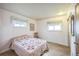 Cozy bedroom featuring a decorative quilt, comfortable carpet, and two windows for natural light at 490 Potomac Way, Aurora, CO 80012