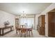 Elegant dining room featuring a classic chandelier, a dark wood dining table, and decorative china cabinet storage at 490 Potomac Way, Aurora, CO 80012
