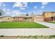 Charming ranch-style home boasts a well-manicured lawn, inviting curb appeal, and an attached two-car garage at 490 Potomac Way, Aurora, CO 80012