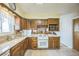 Well-lit kitchen with granite countertops, modern appliances, oak cabinets, and a convenient breakfast bar area at 490 Potomac Way, Aurora, CO 80012
