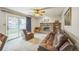 Comfortable living room showcasing a brick fireplace, sliding glass doors to the yard, and ample natural light at 490 Potomac Way, Aurora, CO 80012