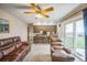Bright and airy room with a ceiling fan, sliding glass doors, and a convenient breakfast bar with seating at 490 Potomac Way, Aurora, CO 80012