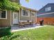 A backyard features a patio with table and chairs, grill, and lush lawn at 1234 Riddlewood Ln, Highlands Ranch, CO 80129