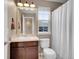 A well-lit bathroom features a vanity, mirror, toilet, and shower with curtain at 1234 Riddlewood Ln, Highlands Ranch, CO 80129