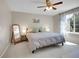 Bright bedroom with a ceiling fan, a comfortable bed, and large windows at 1234 Riddlewood Ln, Highlands Ranch, CO 80129
