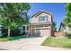Attractive two-story home with manicured lawn, complemented by mature landscaping and a driveway at 1234 Riddlewood Ln, Highlands Ranch, CO 80129