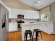 Modern kitchen featuring white cabinets, stainless steel appliances, and a central island at 1234 Riddlewood Ln, Highlands Ranch, CO 80129