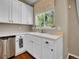 The kitchen has a farmhouse sink, stainless steel dishwasher, and white cabinetry at 1234 Riddlewood Ln, Highlands Ranch, CO 80129