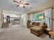 Open concept living room featuring plush seating, large windows, and an open dining area at 1234 Riddlewood Ln, Highlands Ranch, CO 80129