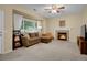 Cozy living room with a fireplace, comfortable seating, and natural light at 1234 Riddlewood Ln, Highlands Ranch, CO 80129
