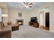 Inviting living room featuring a fireplace, a ceiling fan, and comfortable seating at 1234 Riddlewood Ln, Highlands Ranch, CO 80129