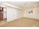 Finished basement with carpet, neutral colors, and access to stairs, creating versatile living space at 846 E 114Th Pl, Northglenn, CO 80233
