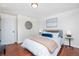 Comfortable bedroom features hardwood floors, neutral decor, and natural light at 846 E 114Th Pl, Northglenn, CO 80233