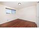Empty bedroom with hardwood floors, a large window, and a closet at 846 E 114Th Pl, Northglenn, CO 80233