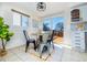 Cozy dining area featuring tile floors, a round table, and a sliding door leading to the deck at 846 E 114Th Pl, Northglenn, CO 80233