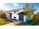 Well-maintained home with green lawn, attached garage, and a mature tree in the front yard at 846 E 114Th Pl, Northglenn, CO 80233