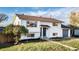 Traditional home featuring a well-manicured lawn, colorful front door, and attached two-car garage at 846 E 114Th Pl, Northglenn, CO 80233