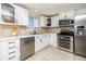 Modern kitchen featuring stainless steel appliances, white cabinets, tile backsplash, and ample counter space at 846 E 114Th Pl, Northglenn, CO 80233