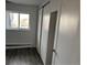 Cozy bedroom with wood-look flooring, a window view, and closet with sliding doors at 1285 N Colorado Blvd # 4, Denver, CO 80206
